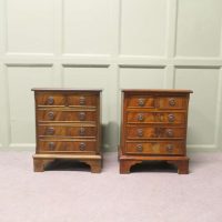 A Pair of Walnut Bedside Chest of Drawers