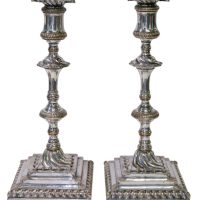 A superb pair of square based candlesticks