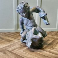 Sculpture of a Cherub Riding a Fish, Fountain Water Feature A superb verdigris patinated
