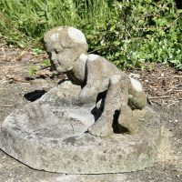 Weathered Garden Bird Bath with a Small Child